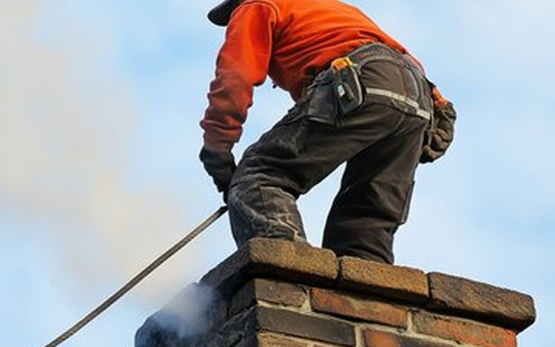 Van Nuys chimney technician making an emergency repair on a brick chimney crown